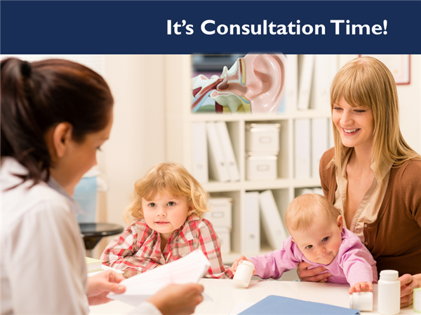 Parent, children and audiologist sitting at table